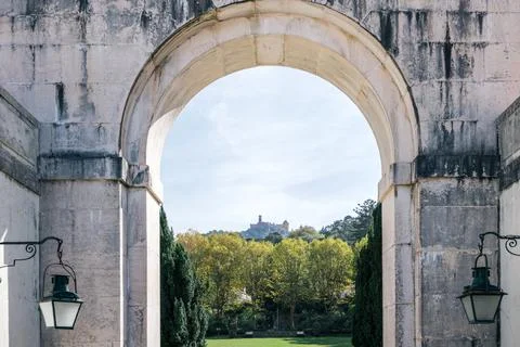 Pena Palace on hill framed by ancient stone arch in Sintra, Portugal Stock Photos