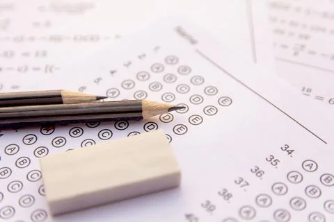 Pencil and eraser on answer sheets or Standardized test form with answers b.. Stock Photos