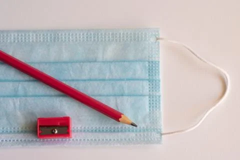 Pencil and mask, necessary objects on the way back to school Stock Photos
