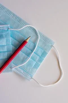 Pencil and mask, necessary objects on the way back to school Stock Photos