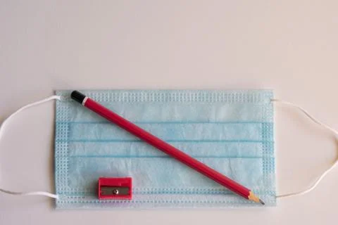 Pencil and mask, necessary objects on the way back to school Stock Photos