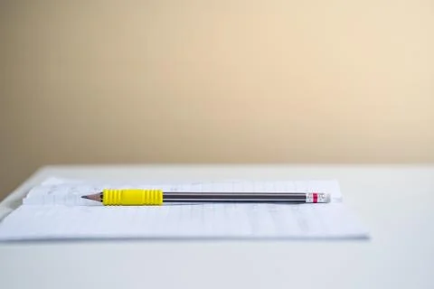 Pencil and note book on table in the room Stock Photos