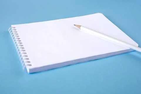 A pencil and a notebook on blue background Stock Photos