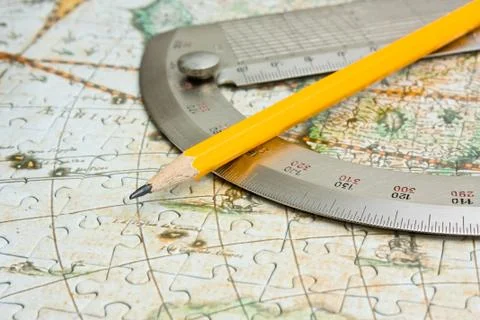 Pencil and  protractor on map Stock-Fotos