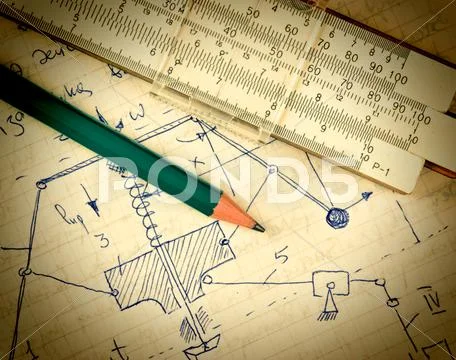 Pencil and a slide rule on the old page with the calculations in mechanics Stock Photos