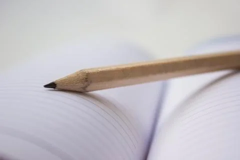 Pencil on a book Stock Photos
