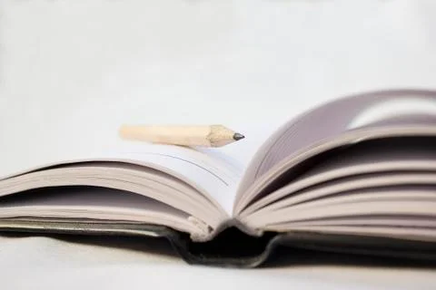 Pencil on a book Stock Photos