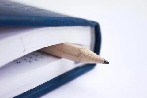 Pencil on a book Stock Photos
