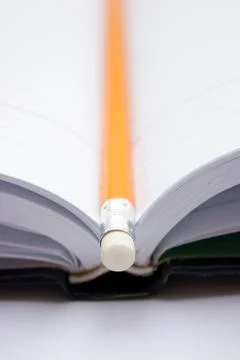 Pencil on a book Stock Photos