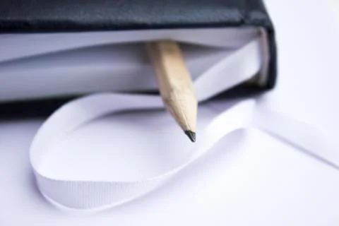 Pencil on a book Stock Photos