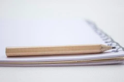 Pencil on a book Stock Photos