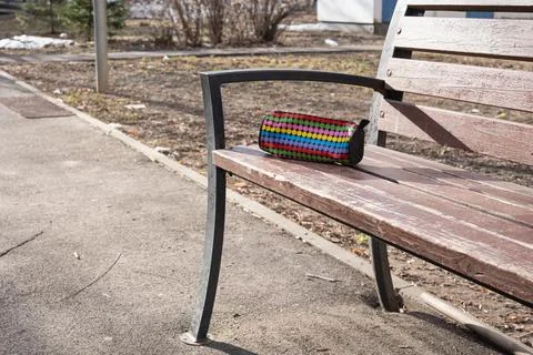 Pencil case with raised dot texture and zipper left on a worn wooden benc Stock Photos