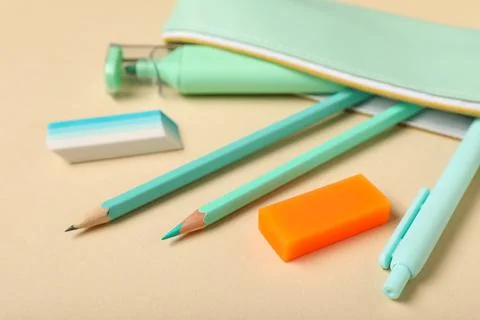 Pencil case with rubber erasers, marker, pen and pencils on beige background, Stock Photos