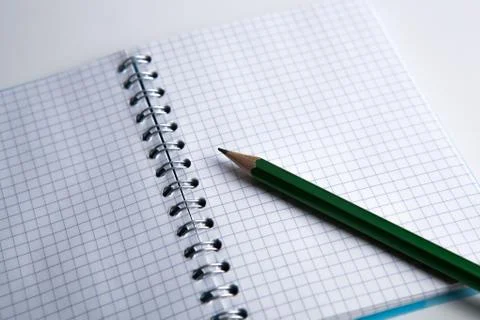 Pencil on the checkered paper exercise book Stock Photos
