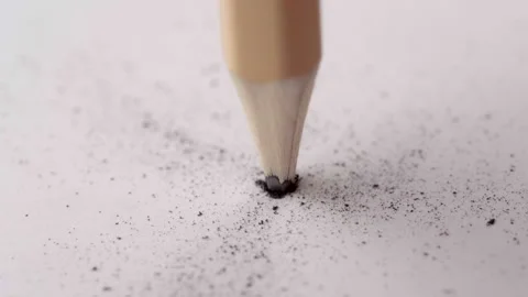 Pencil Lead Close-Up Breaking into Dust Under Pressure on White Paper Video stock 329849566