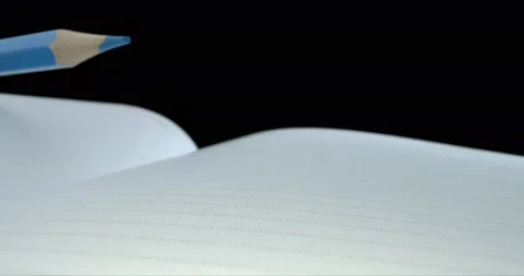 Pencil lies on an open diary. Notepad for notes on a black background. Time Stock Footage 147034051
