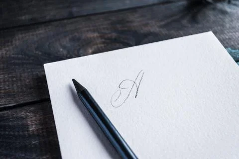 Pencil lying on open notepad with letter on first page Stock Photos