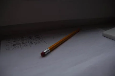 Pencil lying on scribbled paper on the windowsill on a rainy day. on the glas Foto stock
