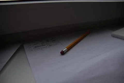 Pencil lying on scribbled paper on the windowsill on a rainy day. on the glas Stock Photos