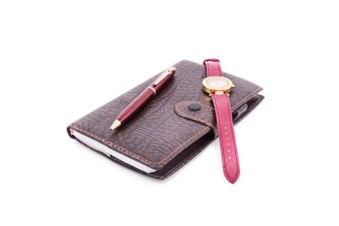 Pencil, notebook and a watch Stock Photos
