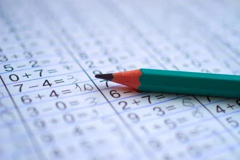 Pencil is on notebook with mathematical examples Stock Photos