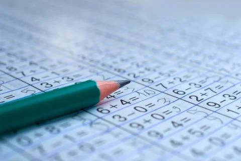 Pencil is on notebook with mathematical examples Stock Photos