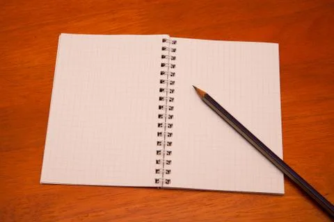 Pencil on a notebook Stock Photos