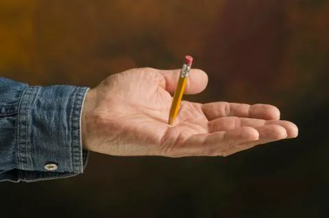 Pencil piercing hand Stock Photos