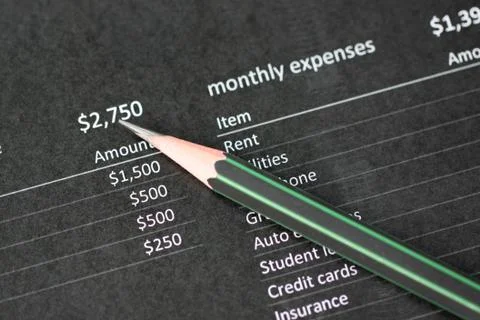 Pencil points to number on data paper. Stockfoto's