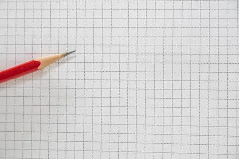 Pencil of red on the grid background Stock Photos