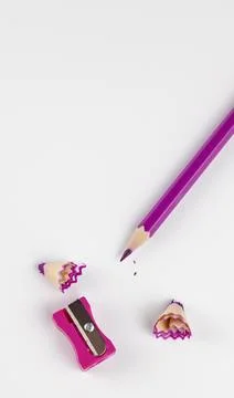Pencil sharpener, sharpened pink pencil with shavings and sharpener, top view. 库存照片