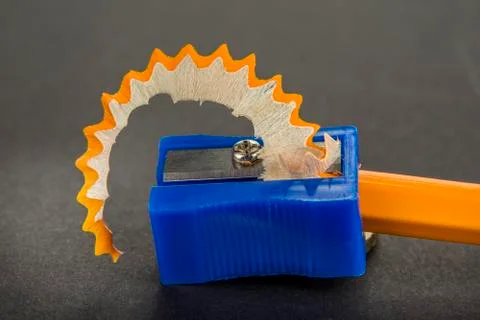 Pencil sharpener with a shaving isolated Stock Photos