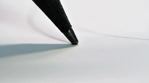 A pencil tip in motion, emphasizing the texture of the graphite and paper Stock Footage 321635329