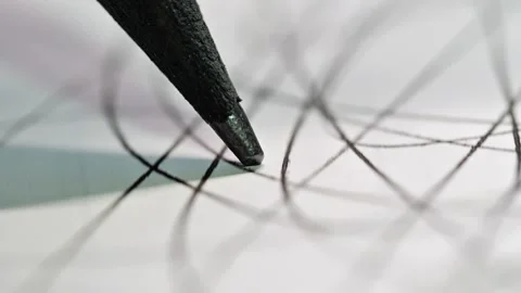 A pencil tip in motion, emphasizing the texture of the graphite and paper Stock Footage 321635339
