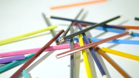 Pencil on a white background. Camera in motion. Colored pencils are in a chaotic Stock Footage 99590681