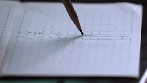 Pencil writing on the textbook Stock Footage 102615833