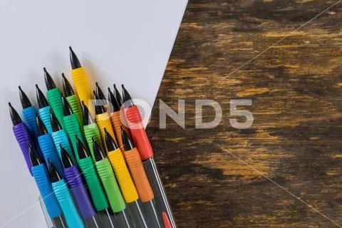 Pencils and drawing pad on wooden background. School stationery. Stock Photos