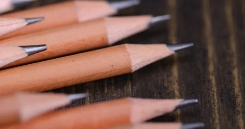Pencils with a black lead on a black pine board , stacked pencils made of wood Stock Footage 321380277