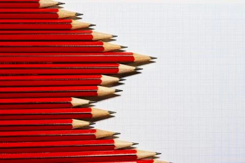 Pencils forming bar graph pattern on graph paper view from above Stock Photos