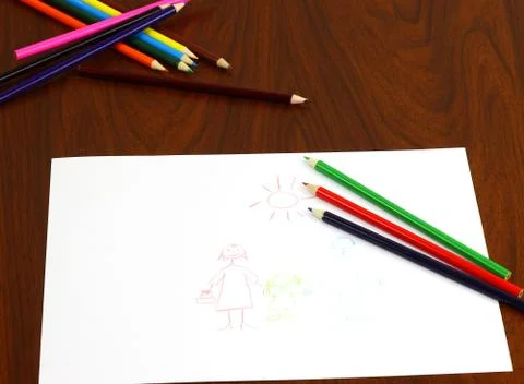Pencils lie on table over the drawing Stock Photos