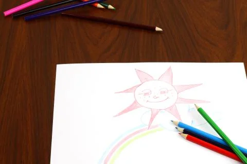 Pencils lie on table over the drawing Stock Photos