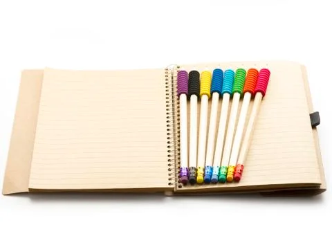 Pencils on notebook Stock Photos
