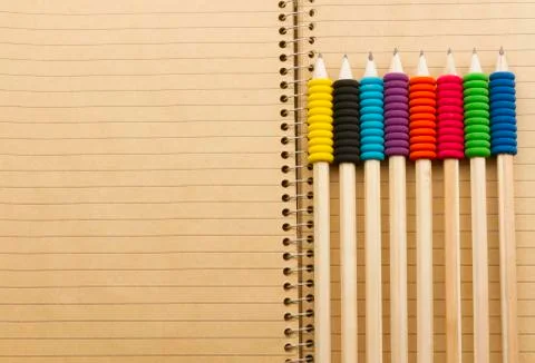Pencils on notebook Stock Photos
