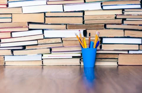 Pencils in plastic holder, stack of books education back to school background Stock Photos