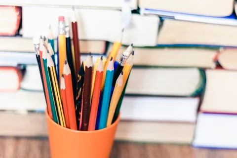 Pencils in plastic holder, stack of books education back to school background Stock Photos