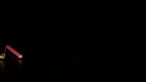 Pencils rolling on a black surface, Ultra Slow Motion Stock Footage 86577507