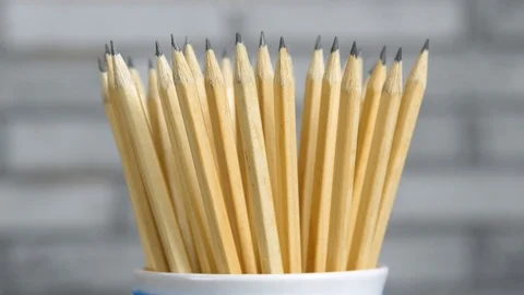 Pencils in the stand rotates on a gray background Stock Footage 89070050