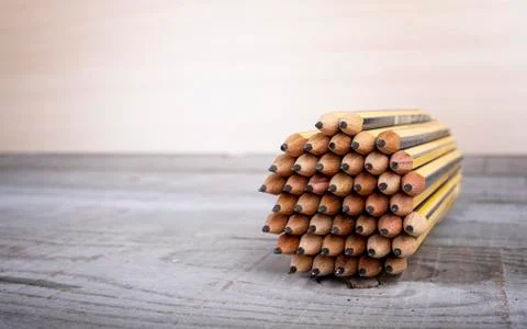 Pencils viewed from front forming a circle with vintage wooden background Stock Photos