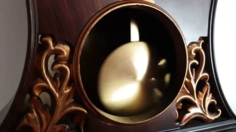 Pendulum clock ticking here and there Stock Footage 165451896