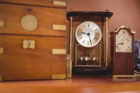 Pendulum clock watch on table Stock Photos